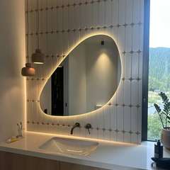 Pebble mirror on arch tiles