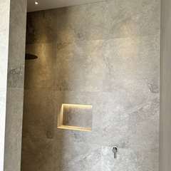 Lit niche in a stone-look shower