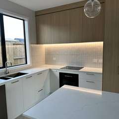 Kitchen with lit splashback