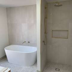 Bath, brass shower, terrazzo floor